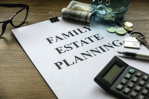 Family estate planning. Property investment and house mortgage financial real estate concept. Document, money, calculator, glasses and key on wooden table.
